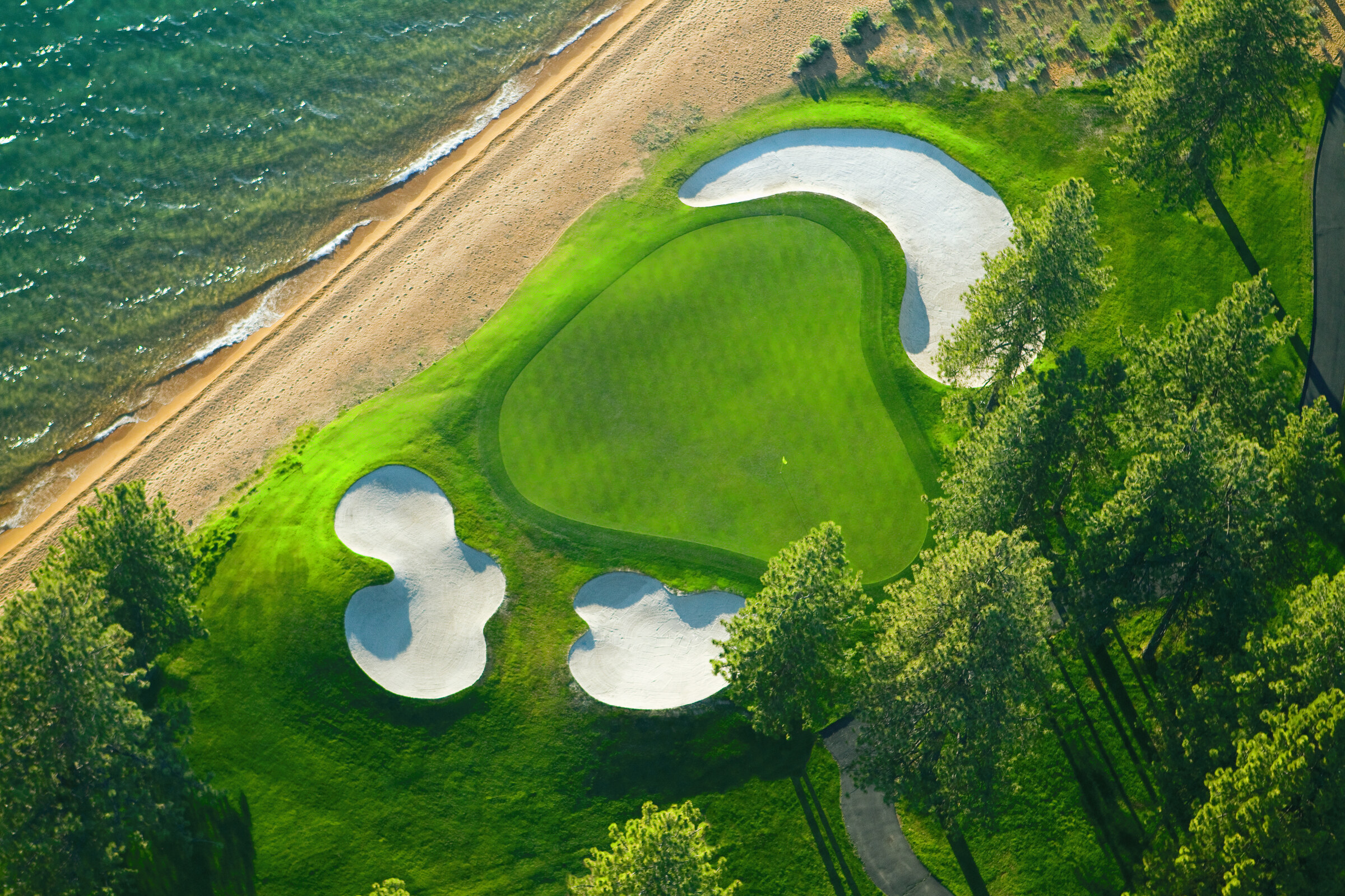 Coastal golf green from above at golden hour